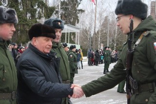 генерал-майор ветеринарной службы В.П. Ветров поздровляет молодого бойца ,принявшего военную присягу